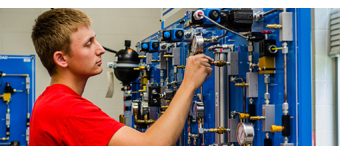 A student adjusts the controls on a systems simulator.